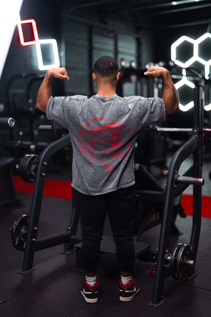 Lifter flexing in Eternal Pump apparel under gym lighting